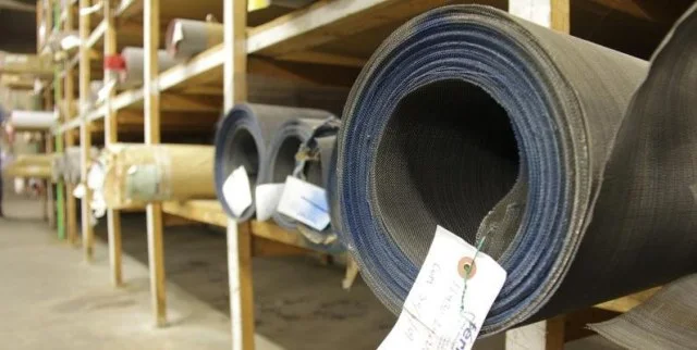 Rolls of mesh tagged and racked